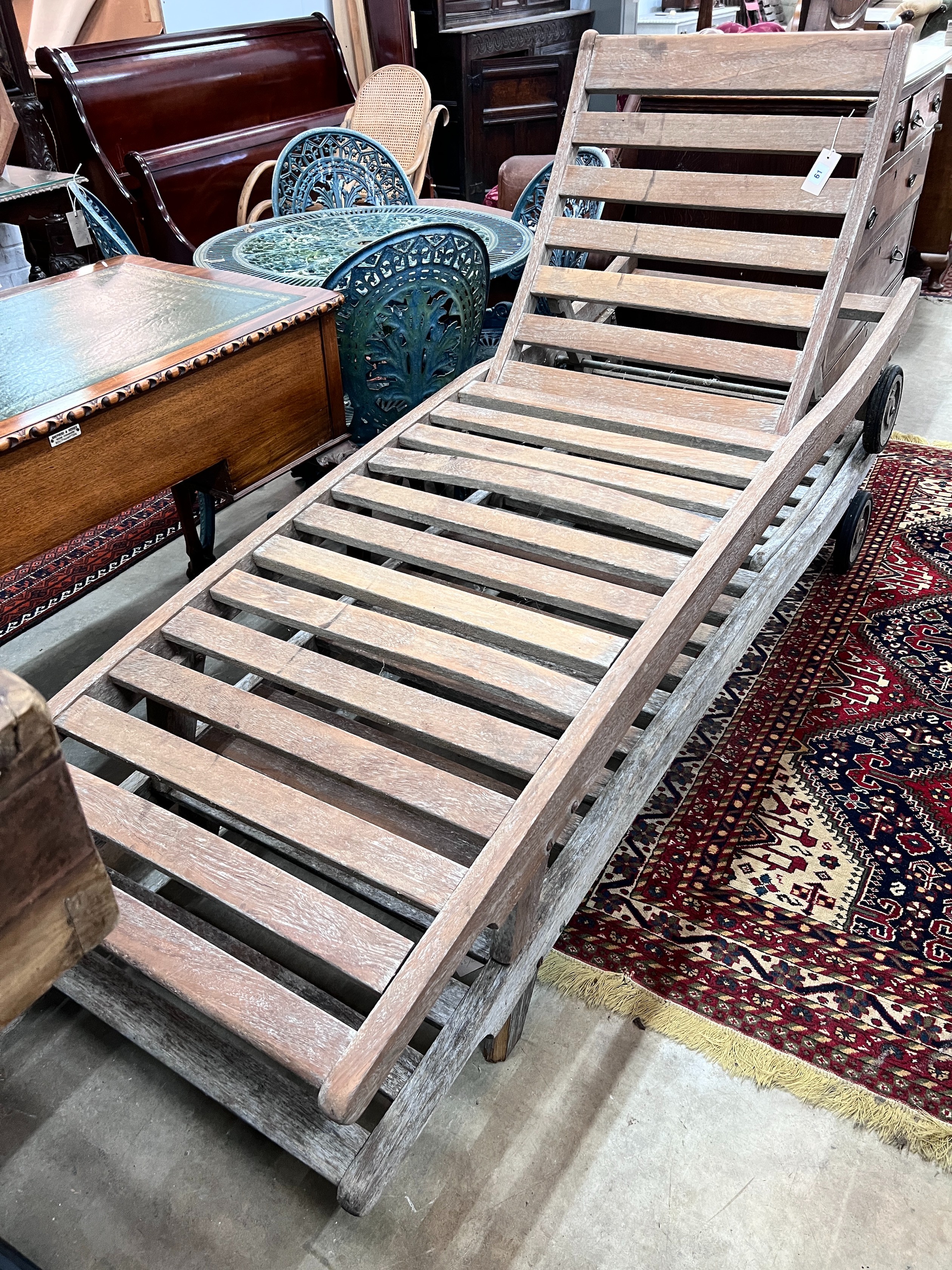 Two weathered teak garden loungers, length 199cm width 69cm *Please note the sale commences at 9am.